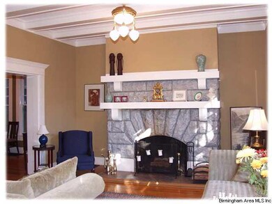 Living room has a charming wood burning fireplace 