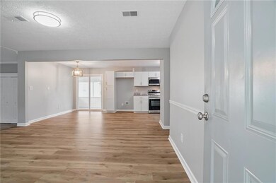 Unfurnished living room with baseboards, visible v