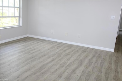 Empty room featuring baseboards and wood finished 