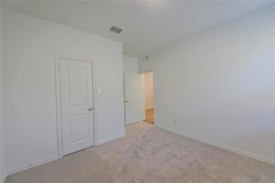 Unfurnished bedroom with light colored carpet