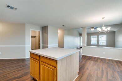 Doorway on the left is the laundry room and overflow pantry storage. The farther doorway leads into the guest wing.   Straight ahead is the dining area with a new light fixture.