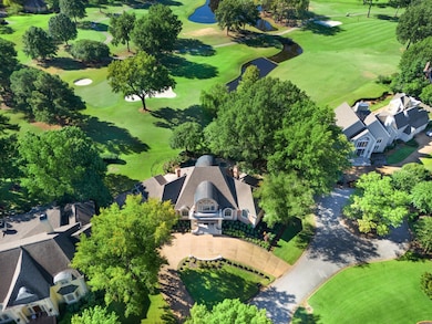 Aerial view of a golf course and a nearby body of water