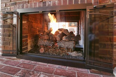 Double sided gas fireplace with custom glass doors