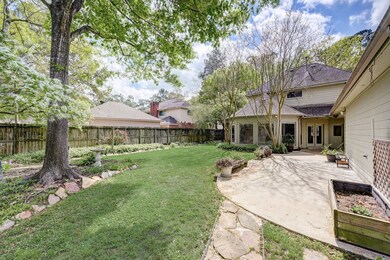 View as you return from the greenbelt walking trails through your private gate.  Mature trees and garden beds welcome you home.