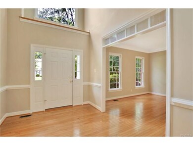 2-Story foyer with wood floor, chair rail, transom