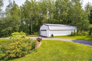 View of yard with an outdoor structure and a garag