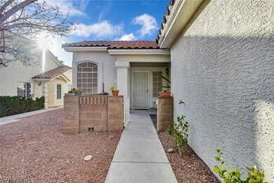 Lovely front courtyard includes white, wrought iro