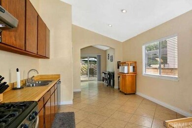 Spacious open kitchen with diagonal laid tile floo
