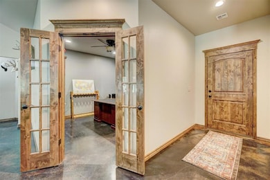 Foyer with ceiling fan and french doors
