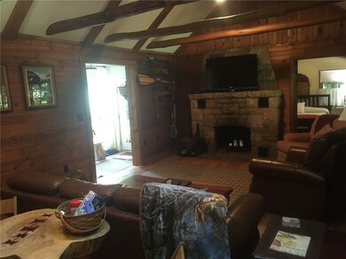Living room with view of stone fireplace
