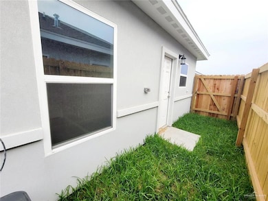 View of side of home featuring stucco siding