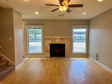 Unfurnished living room featuring ceiling fan, li