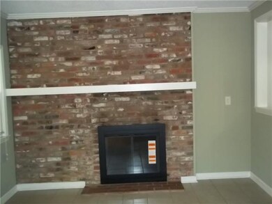 Cozy den off kitchen with fireplace