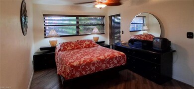 Bedroom with wood-style finished floors and ceiling fan