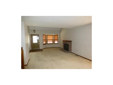 Living room with bay window and fireplace