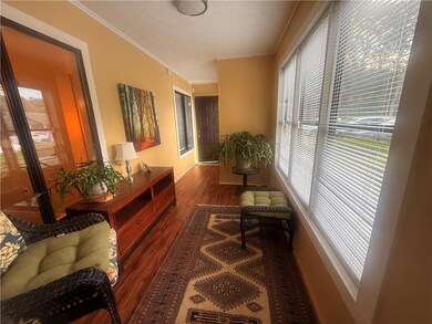 Hallway with wood finished floors, ornamental mold
