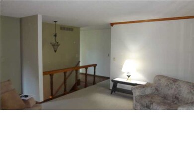 LIVING ROOM WITH OPEN STAIRWAY TO THE LOWER LEVEL