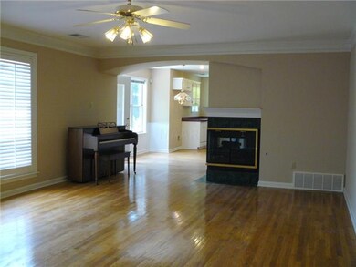 Showcases hardwood floor, crown molding, neutral d