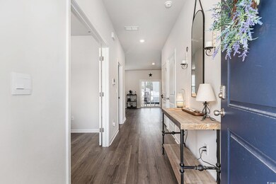 Corridor with wood finished floors and recessed lighting