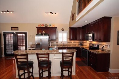 The kitchen features a center island w/breakfast b