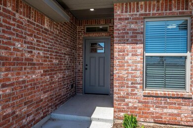 Doorway to property featuring brick siding