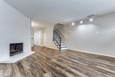 Unfurnished living room with a brick fireplace, da