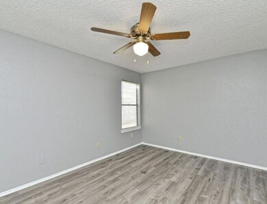 Spare room featuring wood finished floors, a text