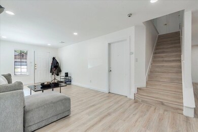 Living area featuring baseboards, wood finished f