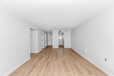 Unfurnished living room with a textured ceiling, c