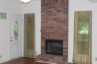 Den with Floor to Ceiling Brick with Fireplace and Windows 