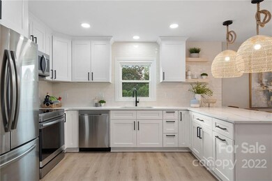 Bright white cabinetry and custom pendant lighting.