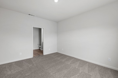 Carpeted empty room with baseboards