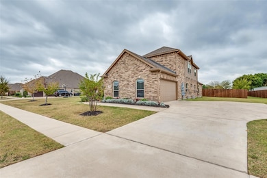 View of front of property featuring a garage and a