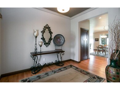 Foyer - tray ceiling, wood floors flow into  home