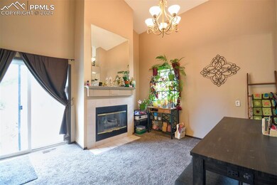 Living room with a chandelier,  fireplace, high va