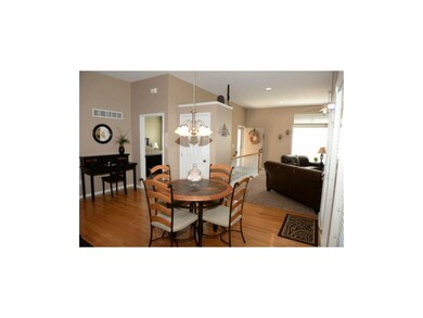 Dining area with gleaming hardwood floor.