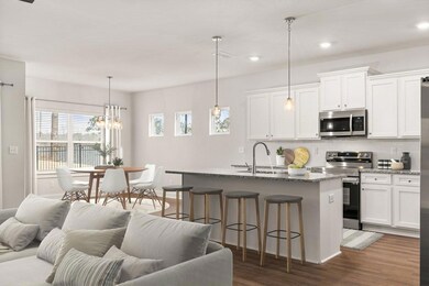 Kitchen with appliances with stainless steel finishes, a sink, open floor plan, tasteful backsplash, and recessed lighting