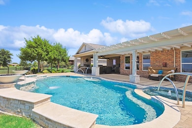 View of pool featuring Water Falls and Fire Bowls