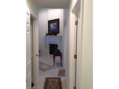 View of fireplace from hallway leading to the bedr