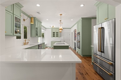 The gourmet kitchen is a chef’s dream, featuring s