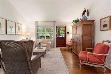 Living area with light wood-type flooring and lofted ceiling