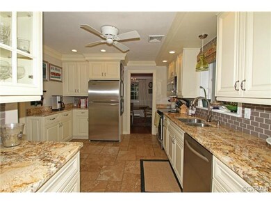 Updated kitchen with granite counters and traverti