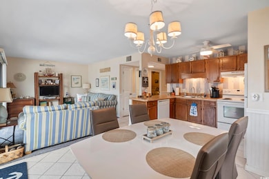 Kitchen featuring hanging light fixtures, light ti