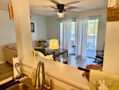 Living area featuring a ceiling fan, wood finished