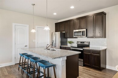 Kitchen with stainless steel appliances, light wo