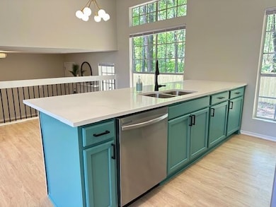 Kitchen with stainless steel dishwasher, a sink, l