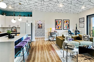 Living room featuring light wood-style floors and baseboards