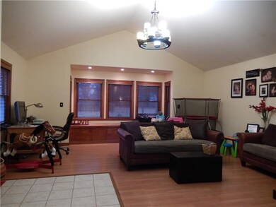 Vaulted great room offers window seat with 5 windo
