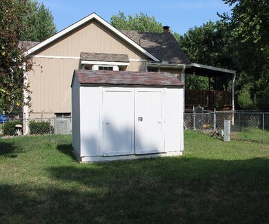 FENCED BACK YARD AND STORAGE SHED.