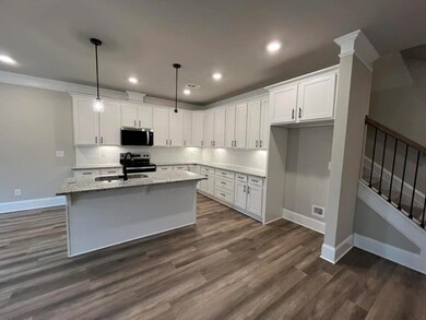 Kitchen with an island with sink, a sink, applianc